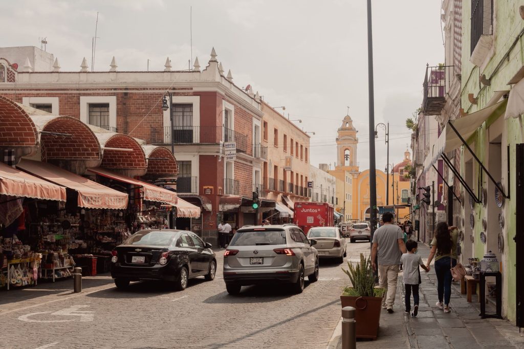 Charming street scene in Puebla, Mexico showcasing historic architecture and daily life.