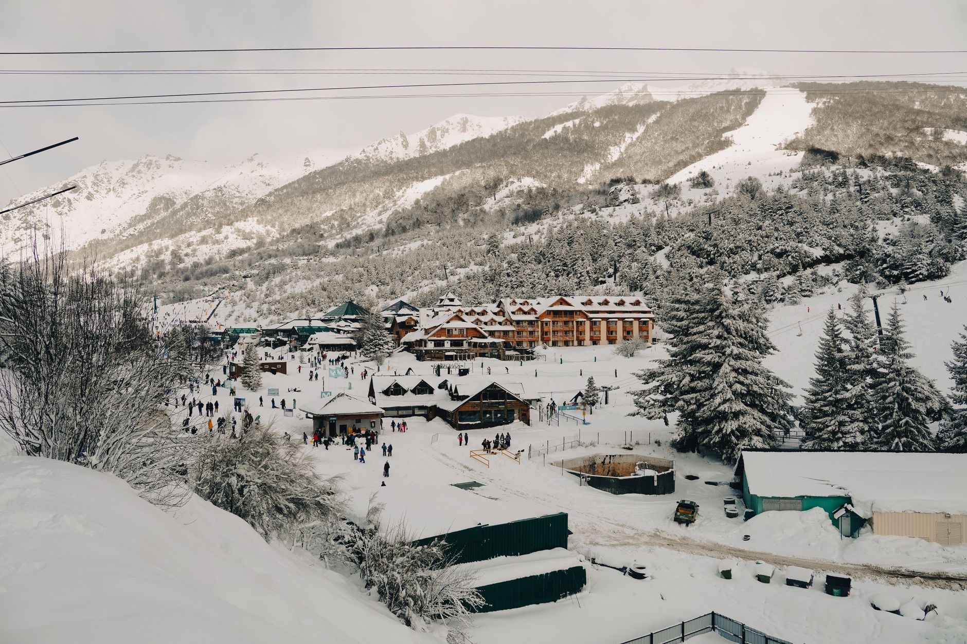 Panoramic view of a snowy ski resort in Bariloche, Argentina, during winter.