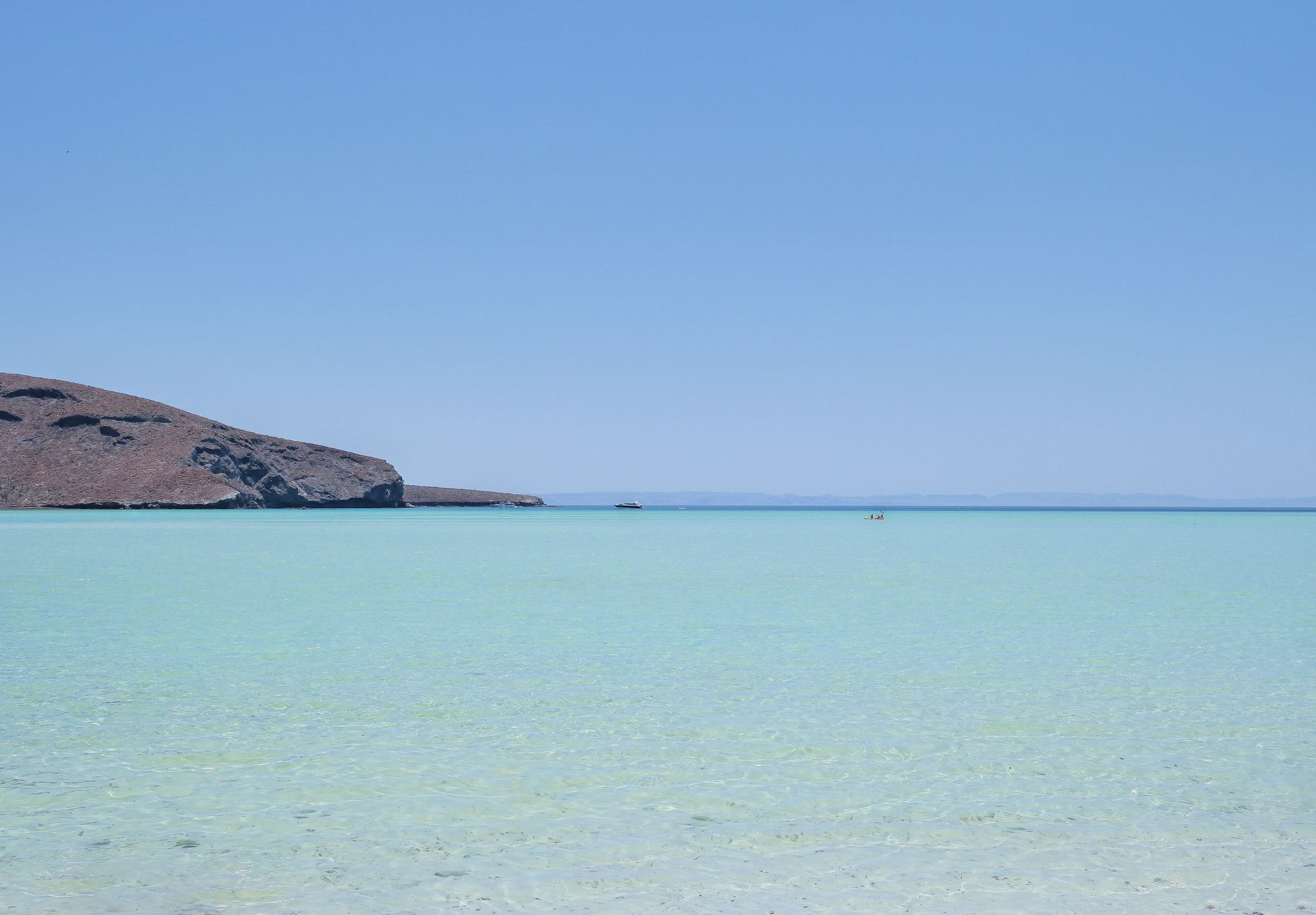 Stunning clear waters and blue sky at Playa Balandra in La Paz, Mexico captured in summer.