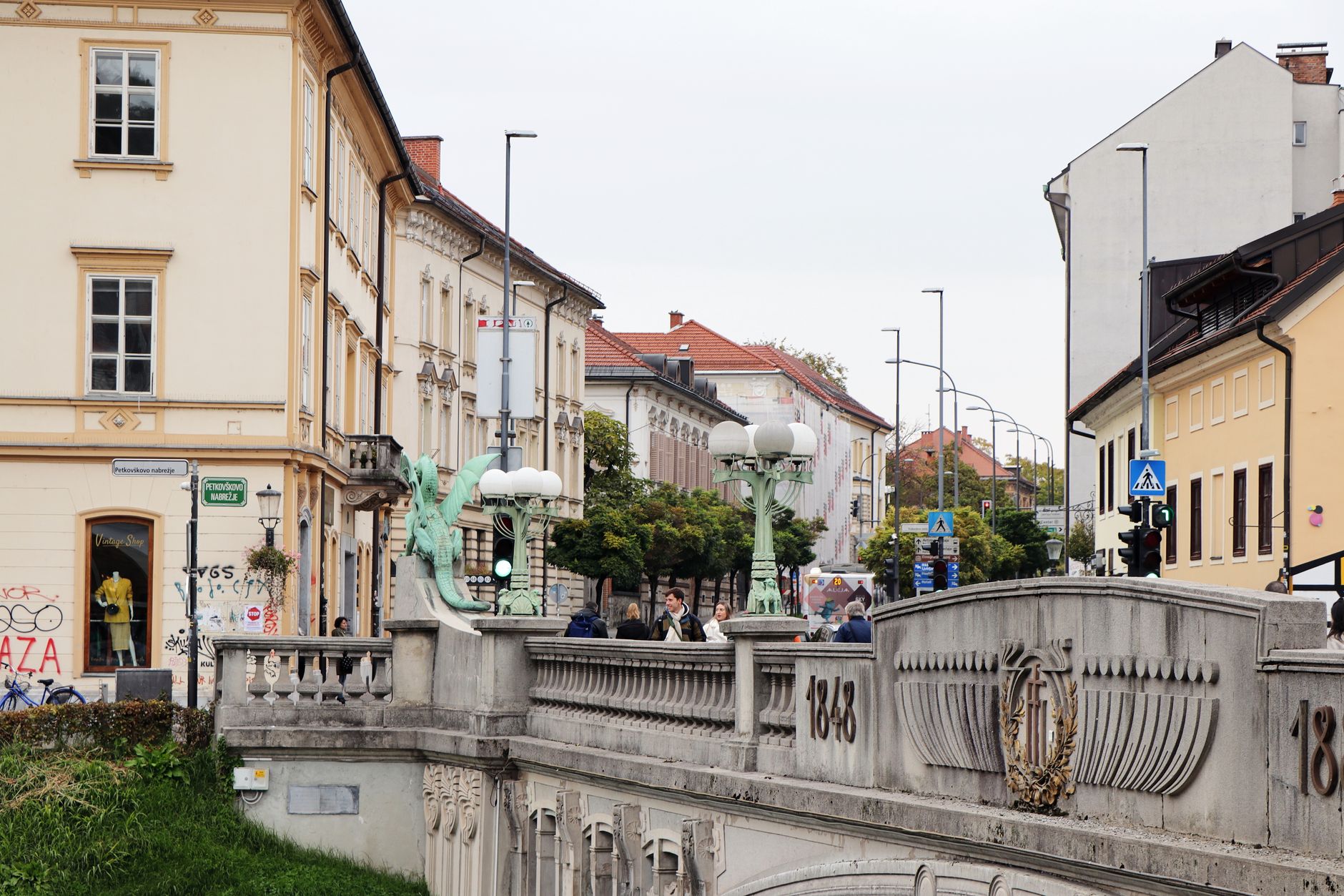 Capturing the historic Dragon Bridge in Ljubljana, Slovenia with its iconic dragon sculptures and urban vibe.