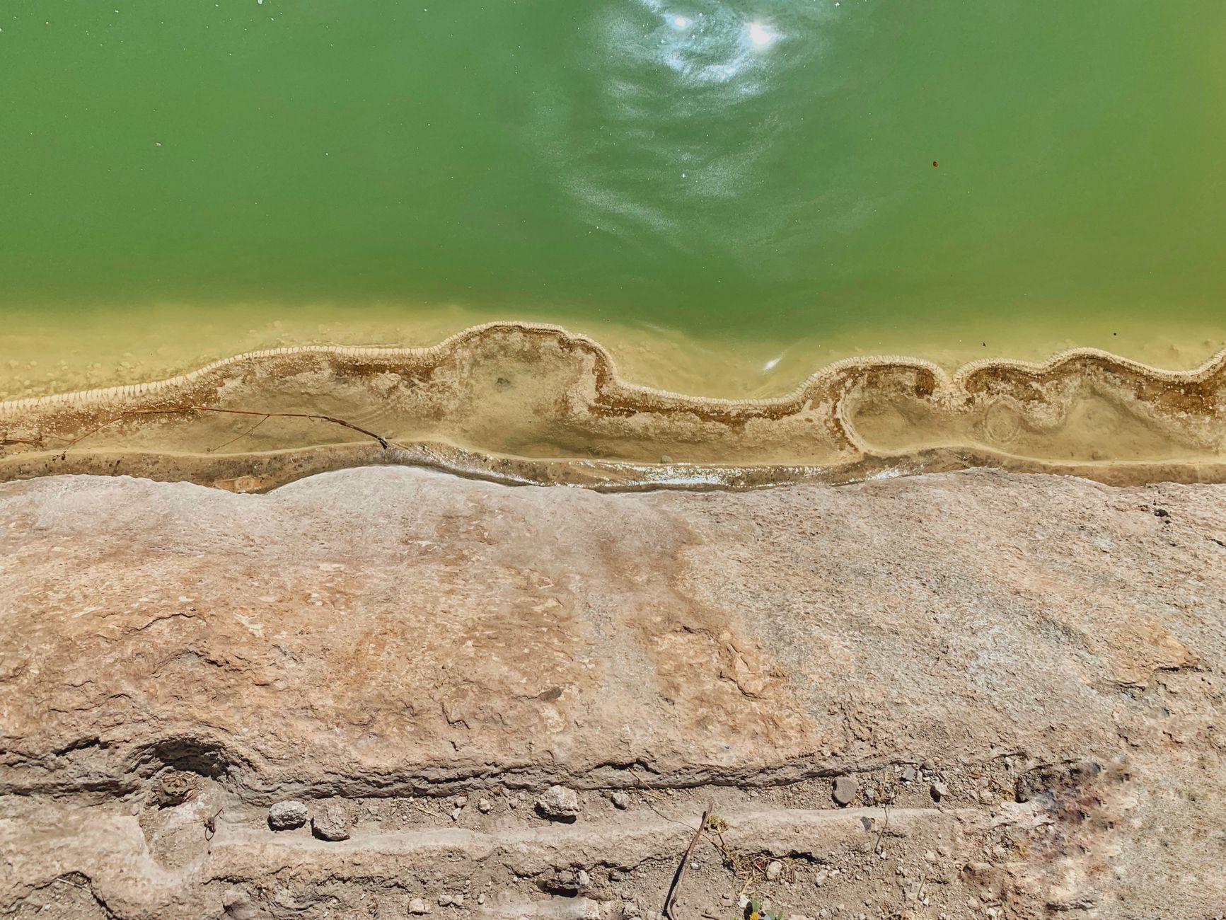 A serene aerial view of the natural formations and green waters at Hierve el Agua, Oaxaca.