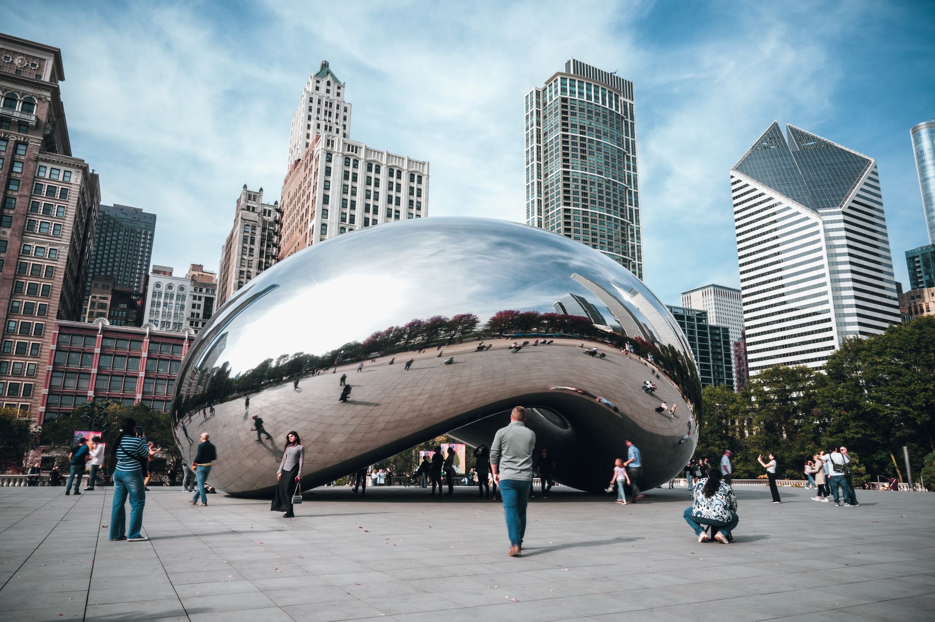 View of Chicago's Cloud Gate sculpture reflecting the city skyline in Millennium Park.