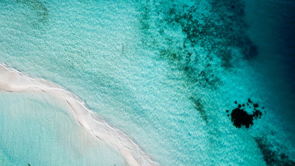 Breathtaking aerial view of a clear blue sea and sandy beach in Dependencias Federales, Venezuela.
