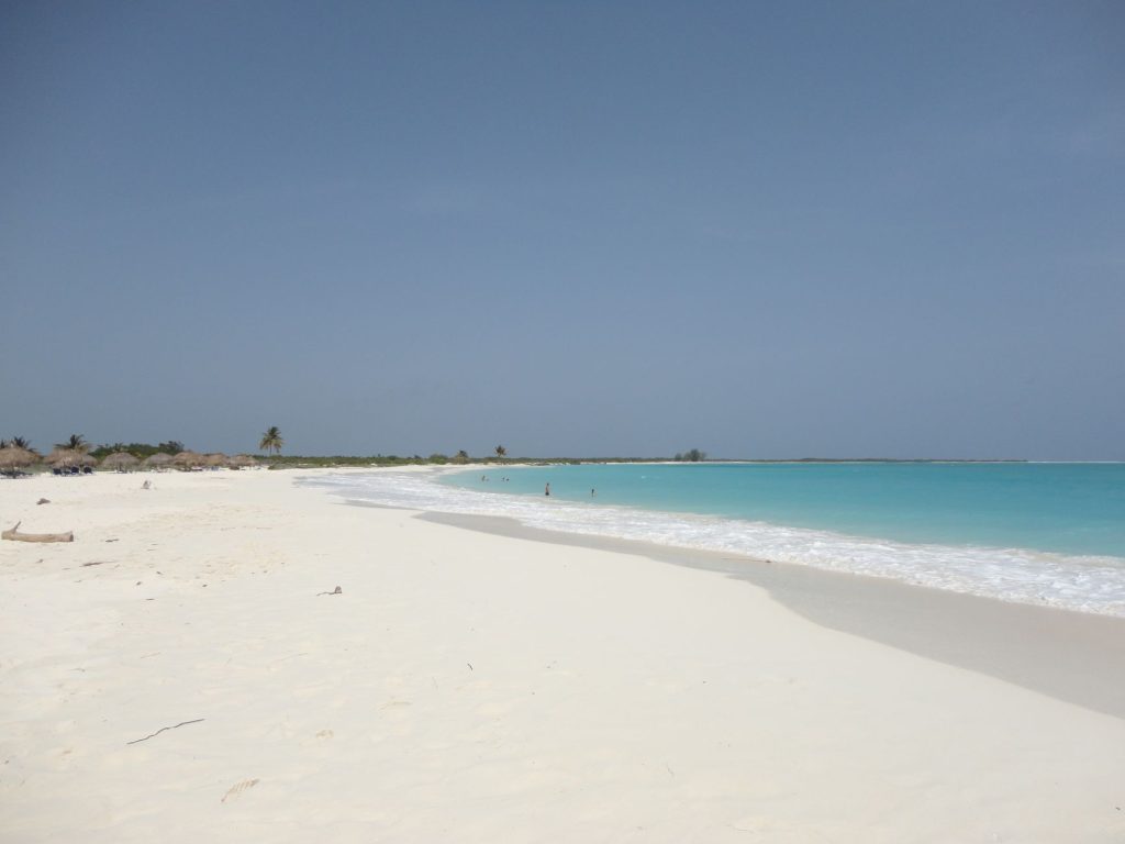 Experience the serene beauty of Cayo Largo's unspoiled beach with azure waters and soft white sand.