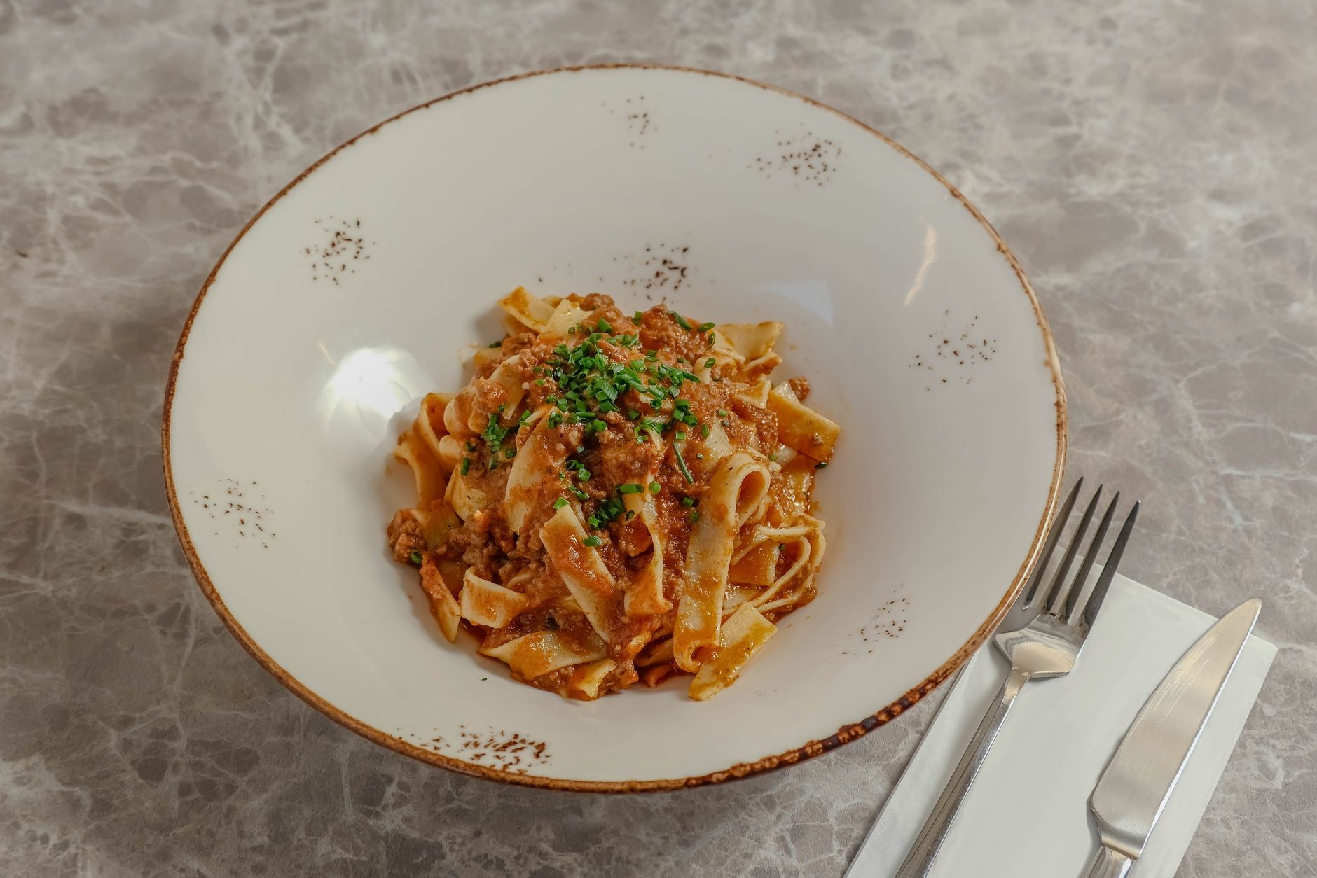 Close-up of classic Italian pasta Bolognese plated elegantly.