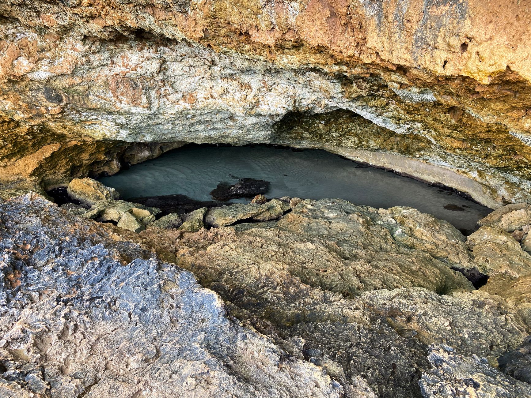 Explore a breathtaking sea cave with stunning rock formations in Aruba.