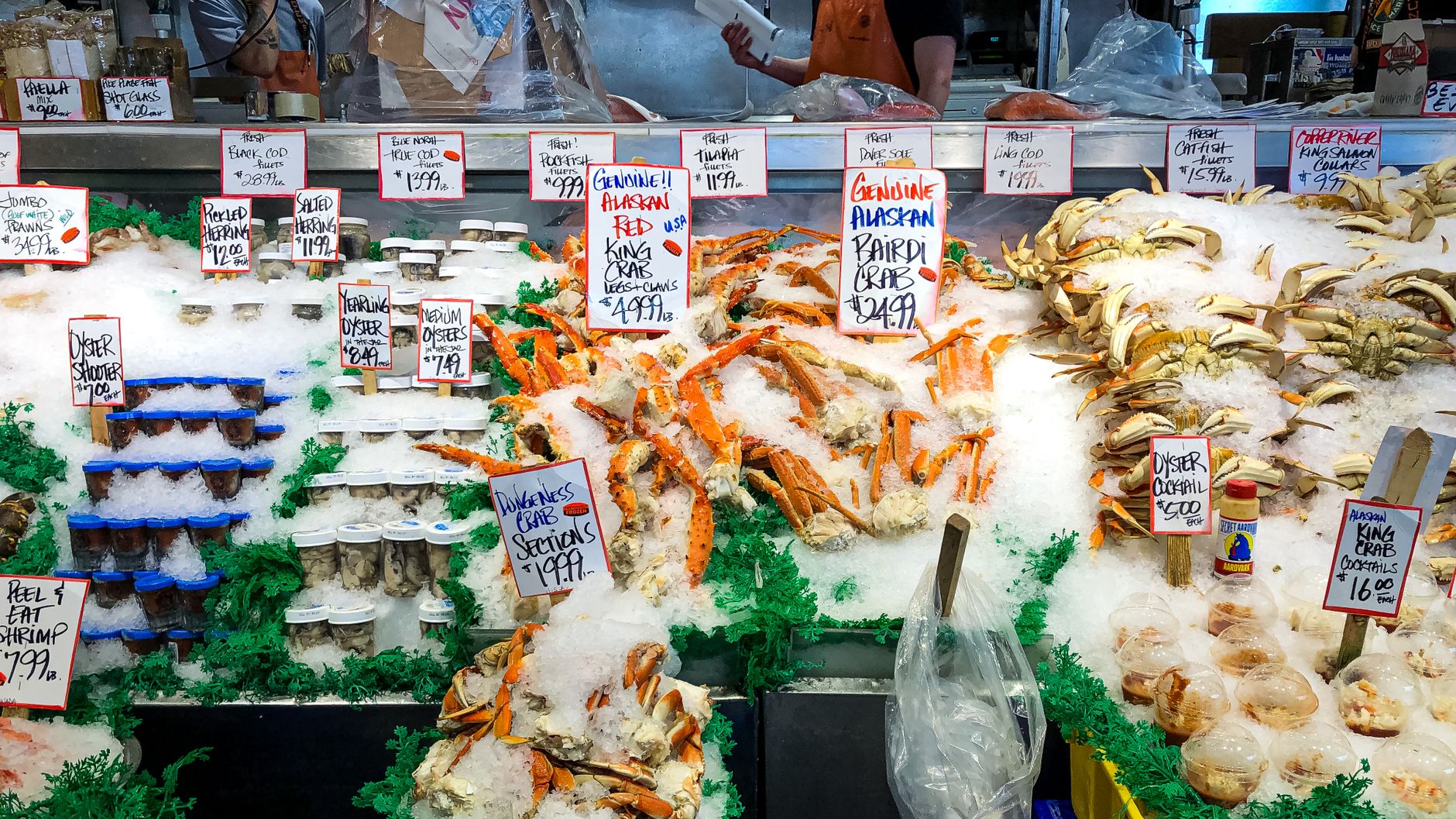 Fresh seafood display with crabs and oysters at a market in Seattle.