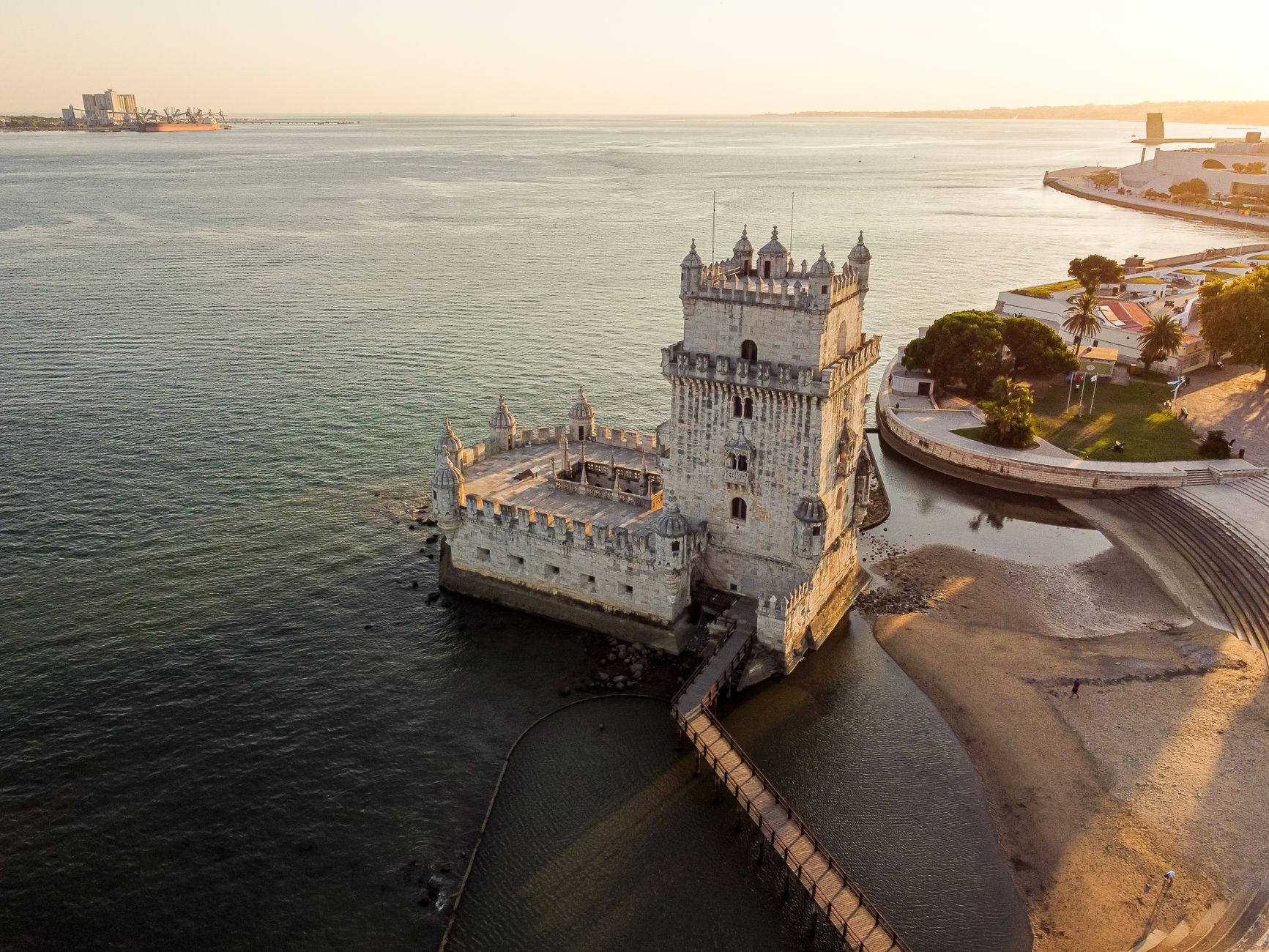 A stunning aerial view of Belém Tower in Lisbon, Portugal during sunset.