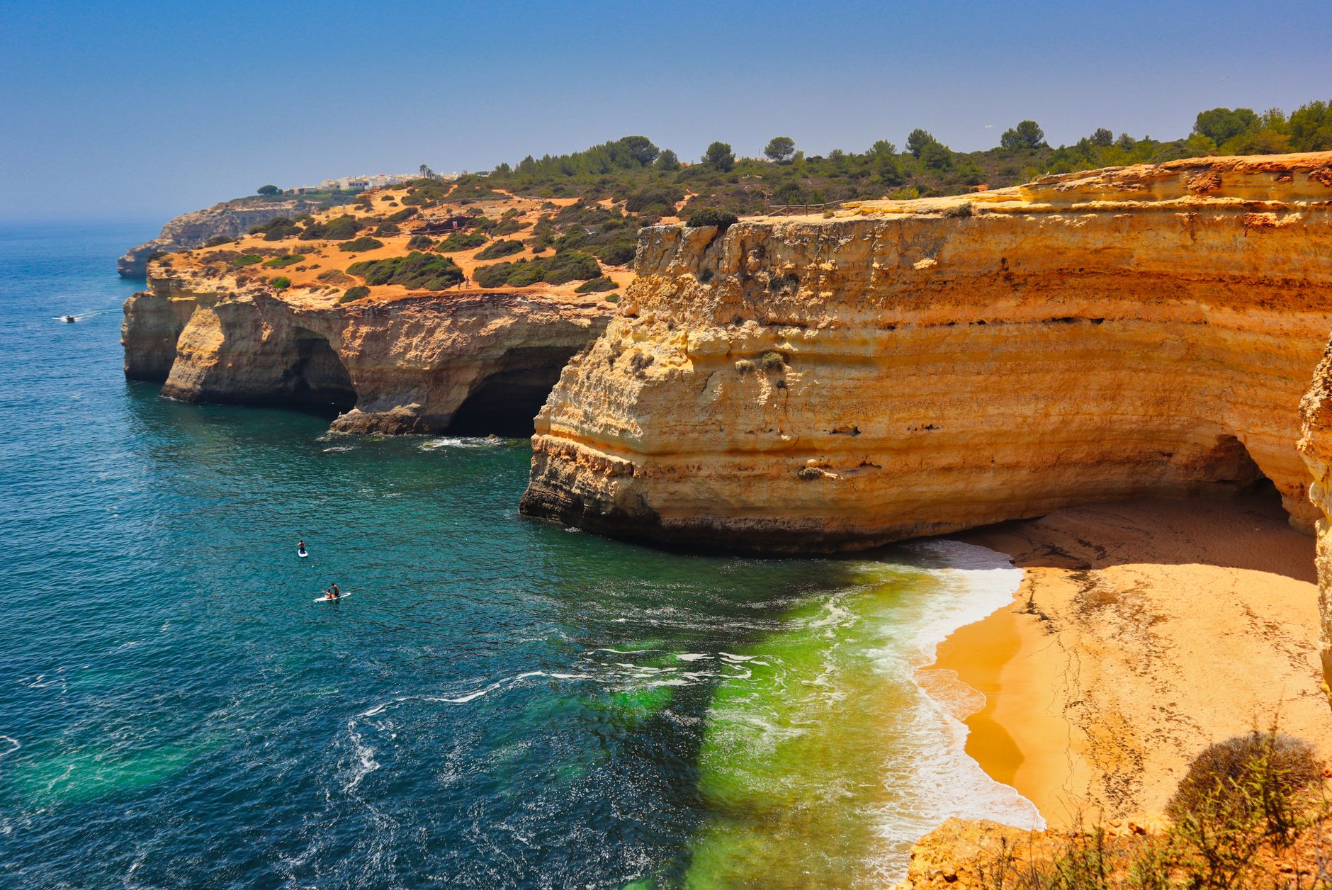 A breathtaking aerial view of Algarve cliffs and turquoise waters in Portugal's Praia de Corredoura.