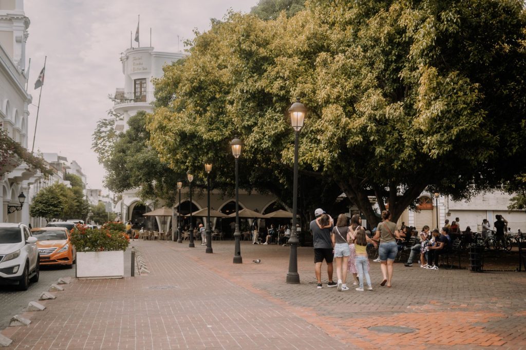 Peaceful park view with historic buildings and people enjoying leisure time.