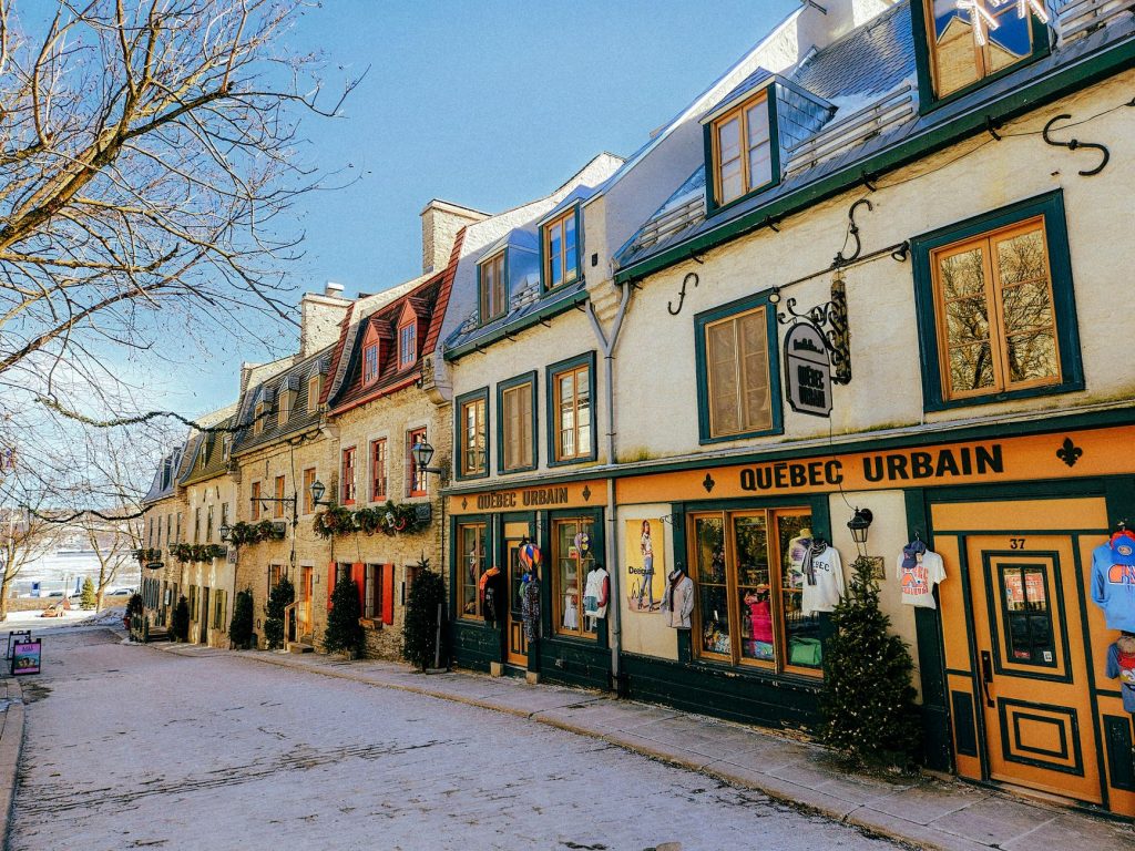 Picturesque winter scene of historic Rue du Petit-Champlain in Quebec City, showcasing colorful colonial-style architecture.