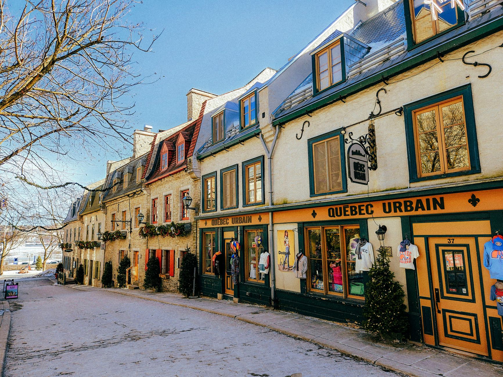 Picturesque winter scene of historic Rue du Petit-Champlain in Quebec City, showcasing colorful colonial-style architecture.