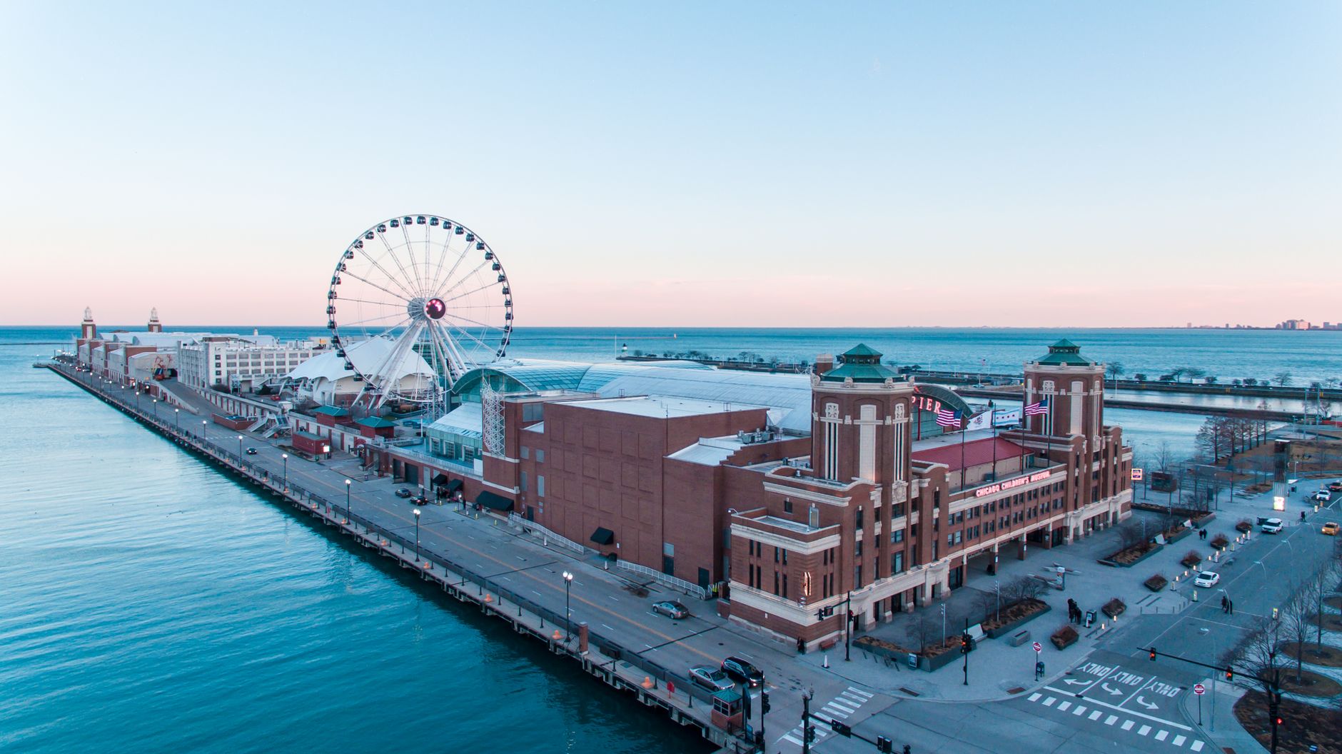 Stunning aerial view of Chicago's Navy Pier with the iconic Ferris wheel at sunset.