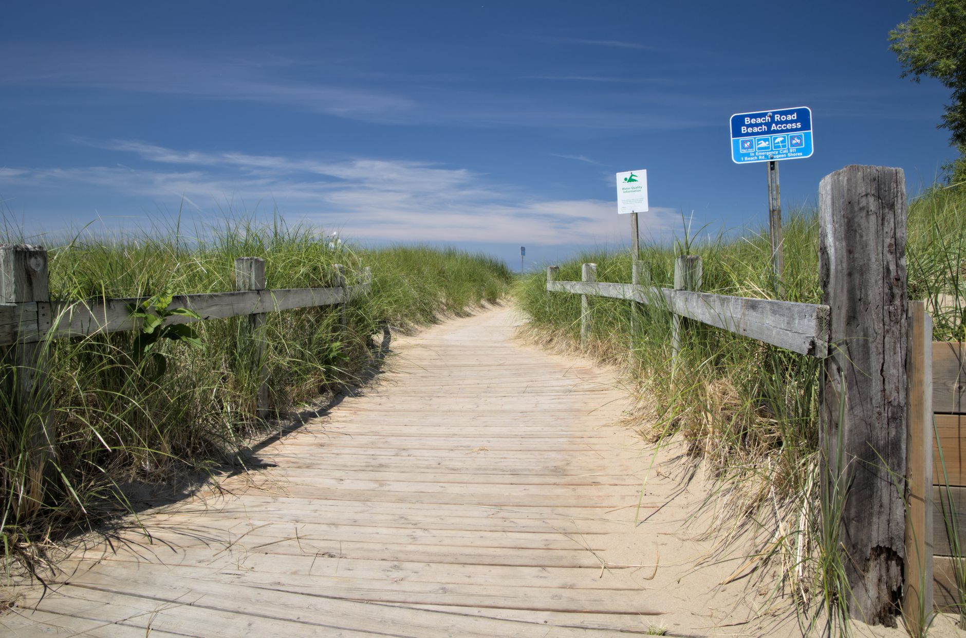 A sunny wooden path through dunes leads to Southampton Beach in Ontario, Canada.