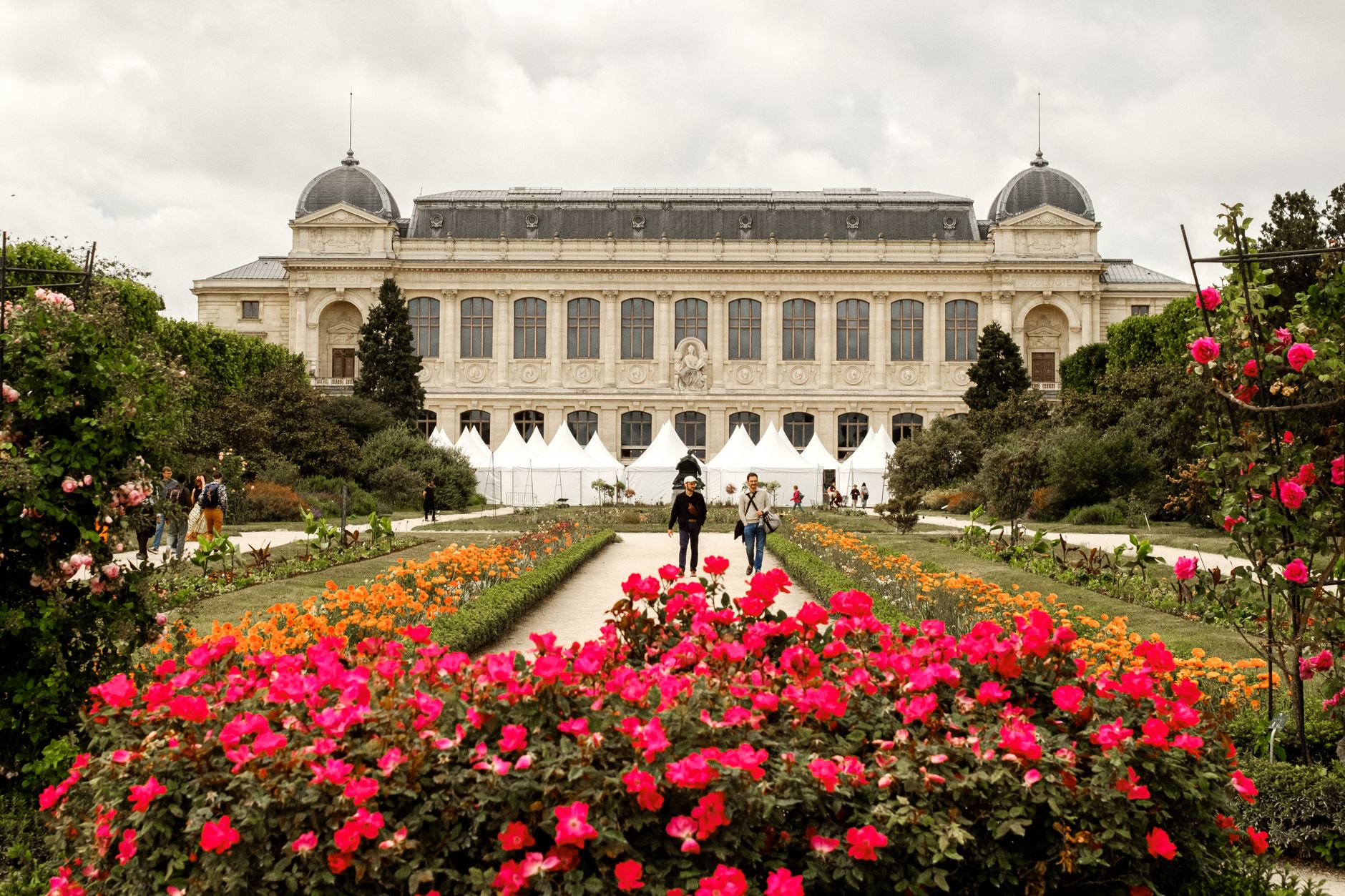 Scenic view of Jardin des Plantes with stunning floral displays and historical architecture in Paris.