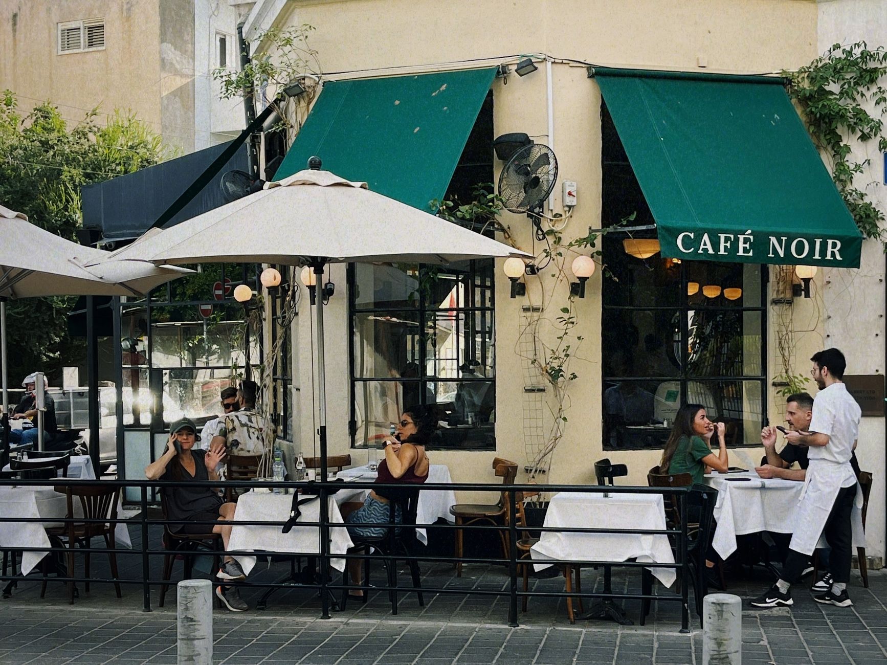 Enjoying a pleasant meal at Café Noir on the vibrant streets of Tel Aviv.