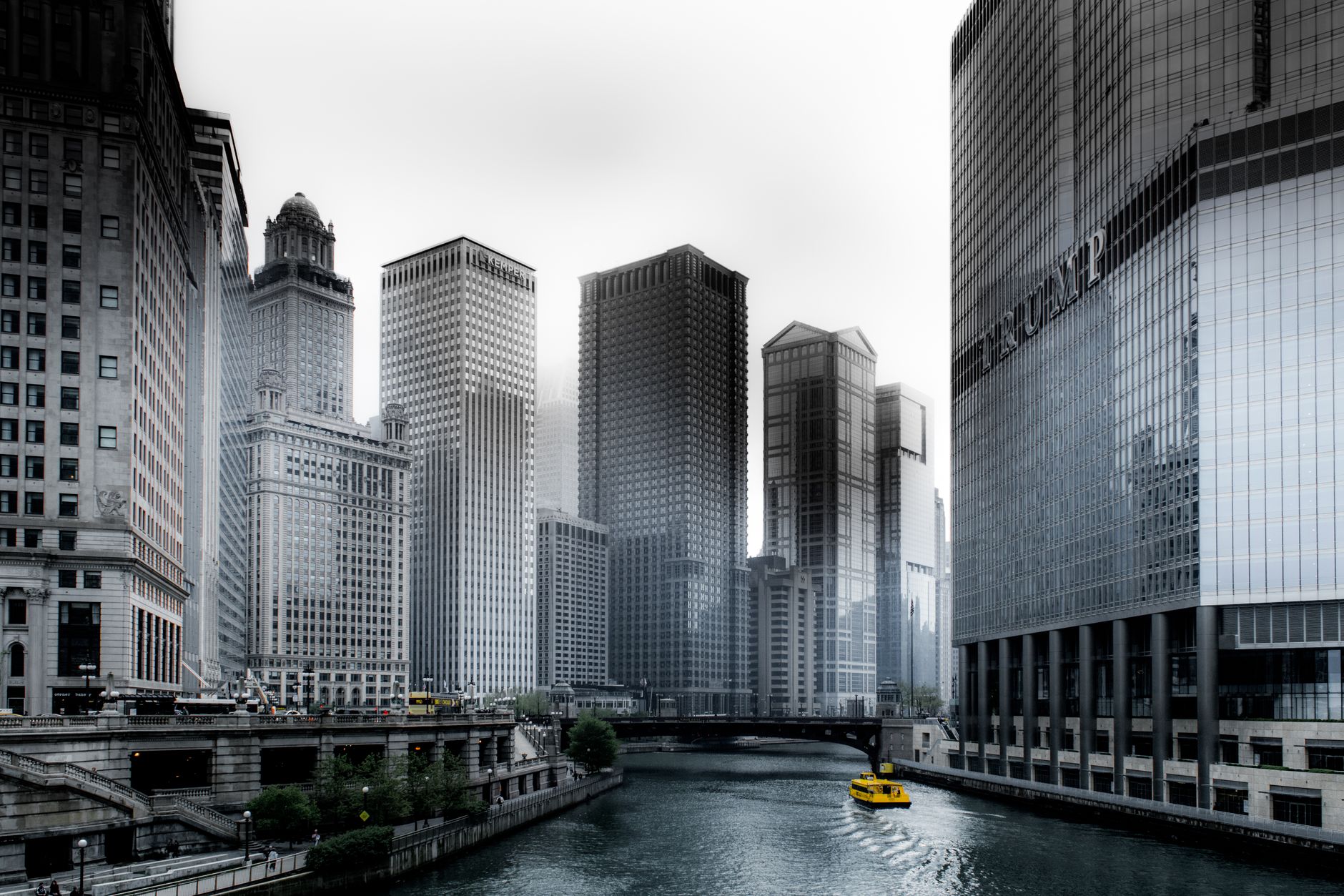 Stunning view of Chicago's skyscrapers along the river with a yellow water taxi.