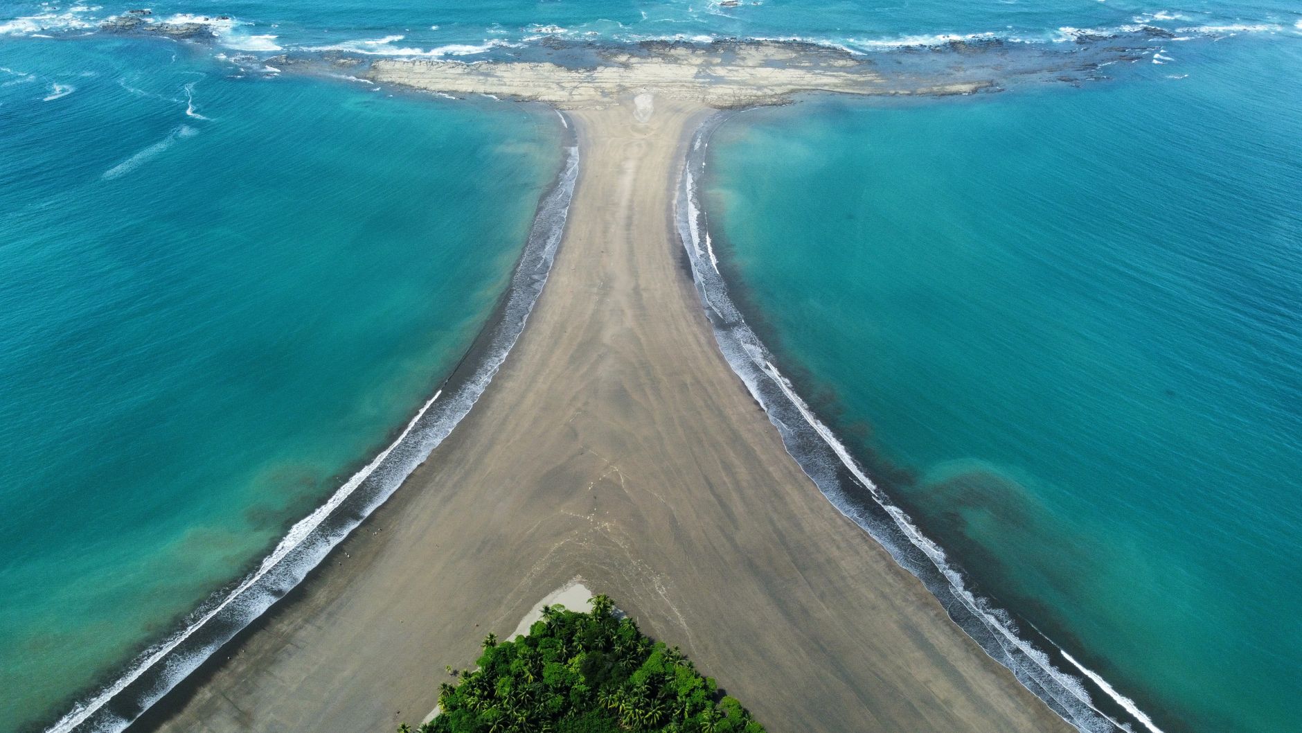 Stunning aerial view of the Whale Tail rock formation along the beach in Uvita, Costa Rica.