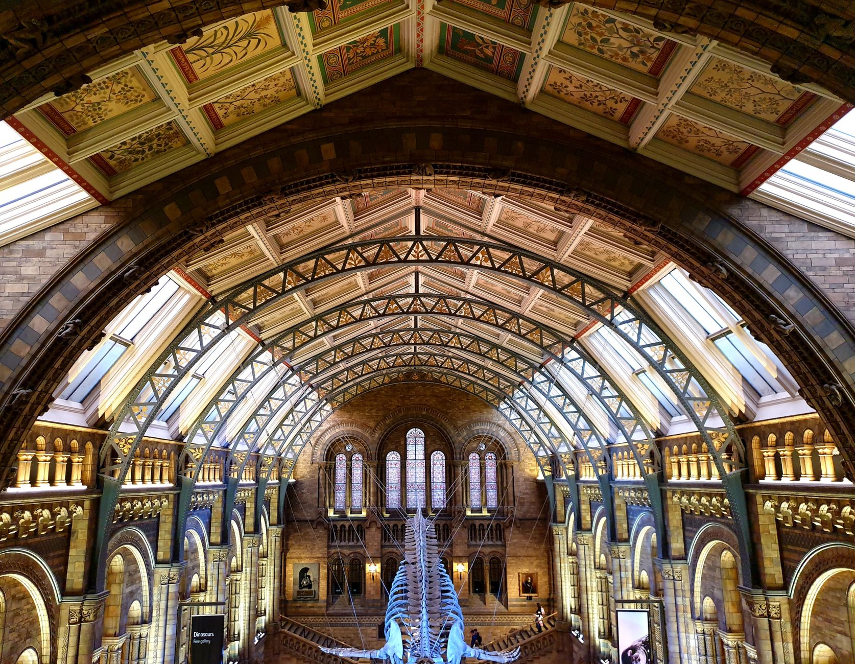 Intricate architectural details of the Natural History Museum's grand central hall in London.