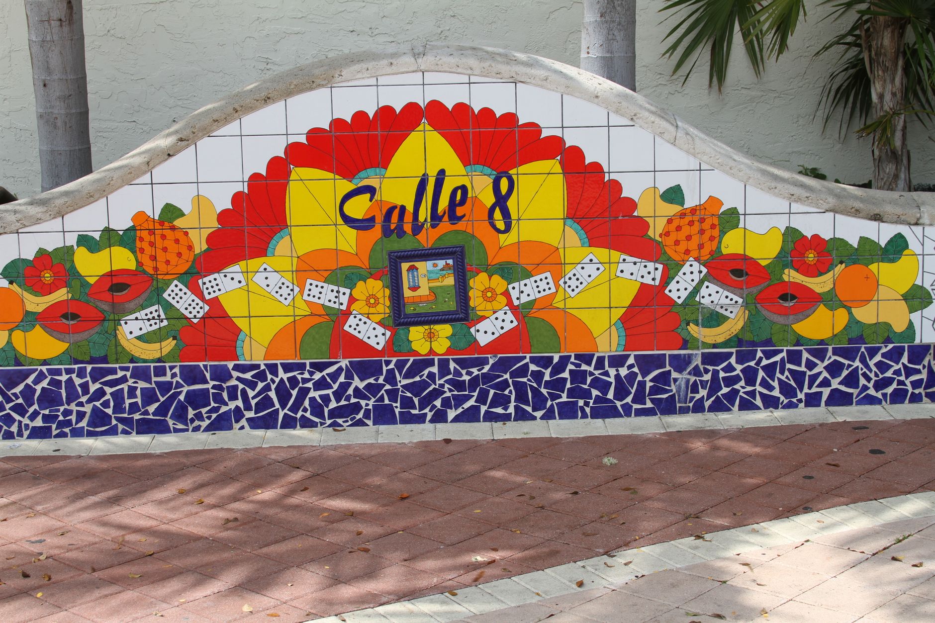 Vibrant mosaic mural in Little Havana, Miami featuring Calle 8 with colorful fruits and dominoes.