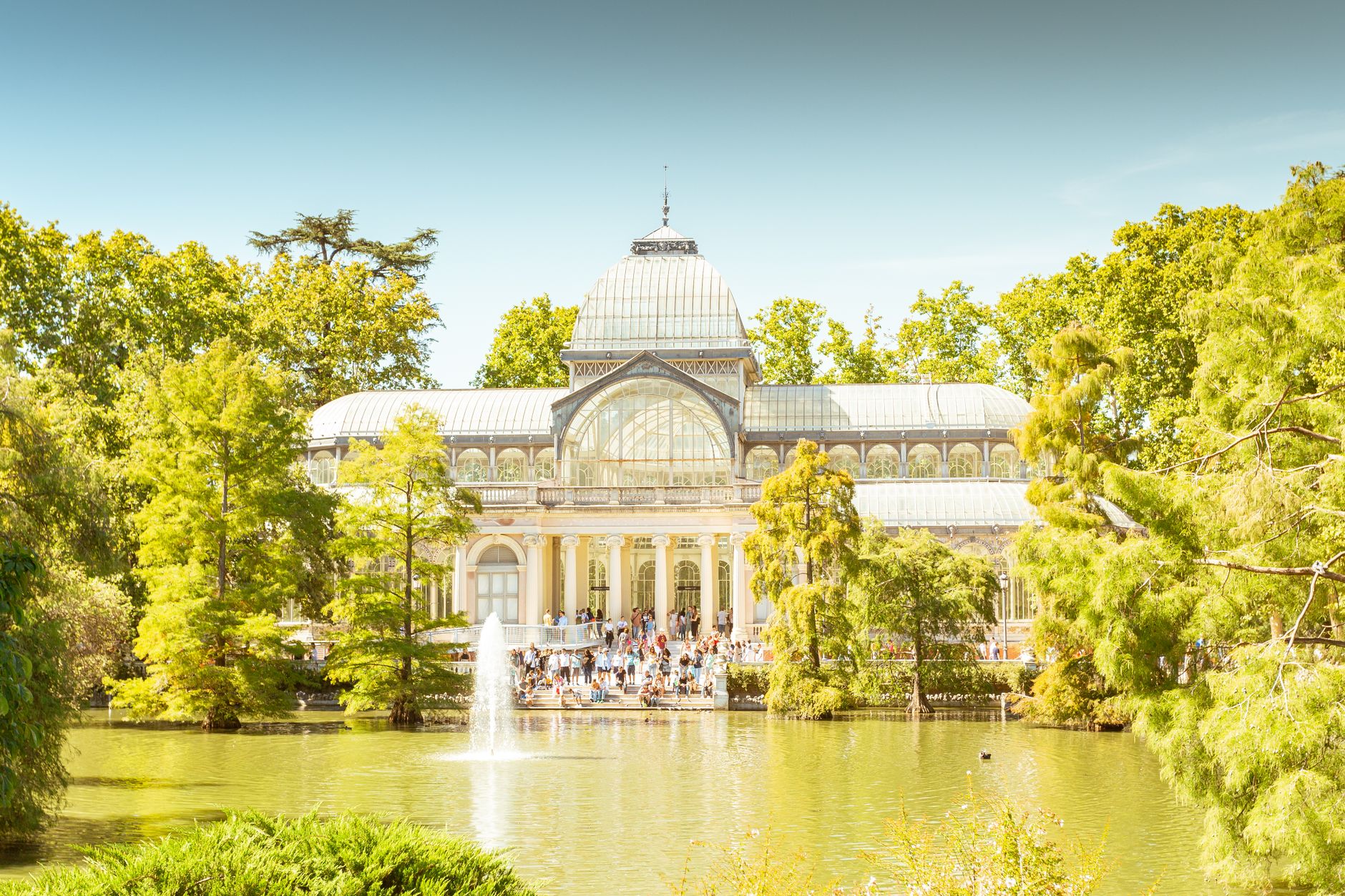 Beautiful conservatory by a pond in Buen Retiro Park, Madrid, Spain, on a sunny day.
