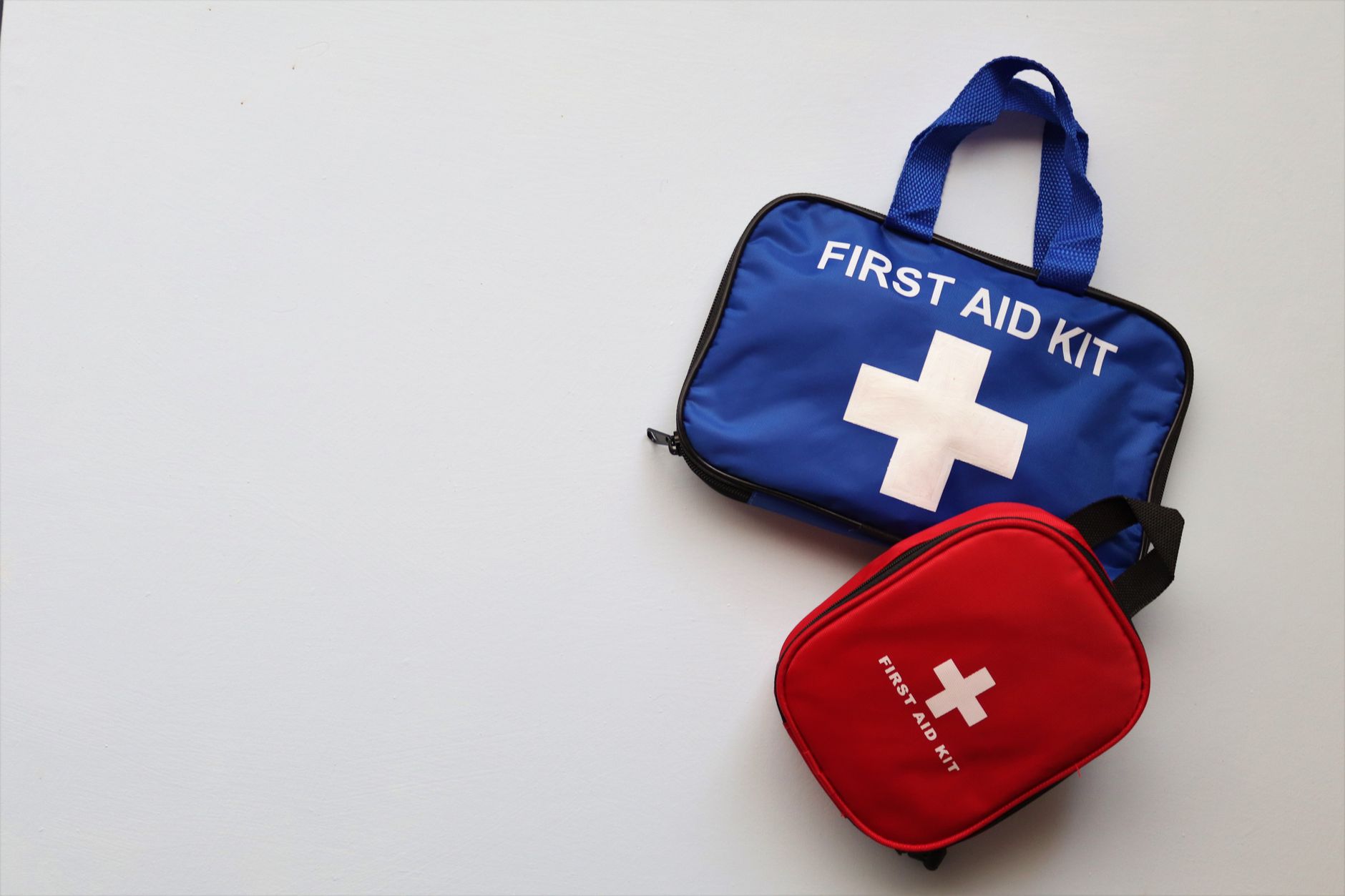 Two first aid kits on a white background with ample copy space.