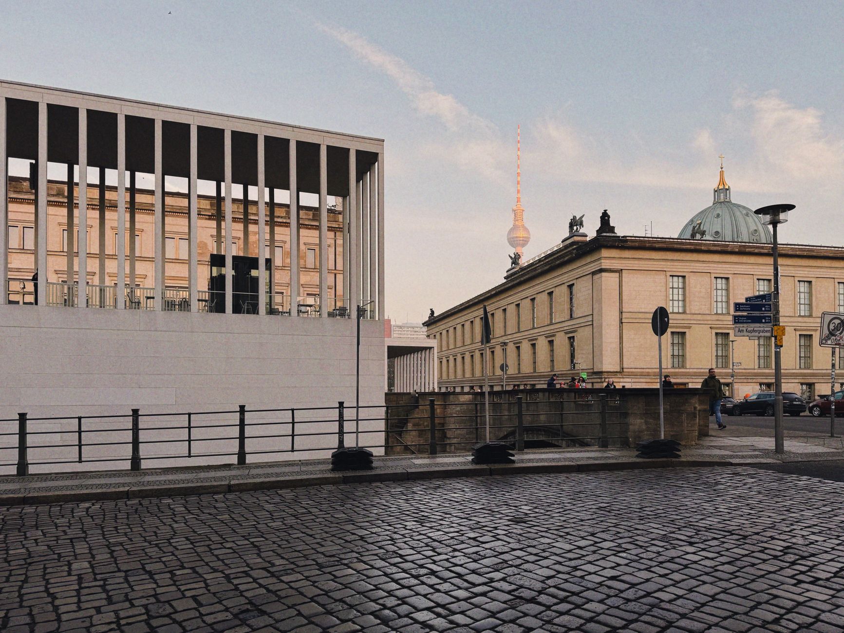 Modern and classic Berlin architecture featuring the iconic Fernsehturm under a clear sky.
