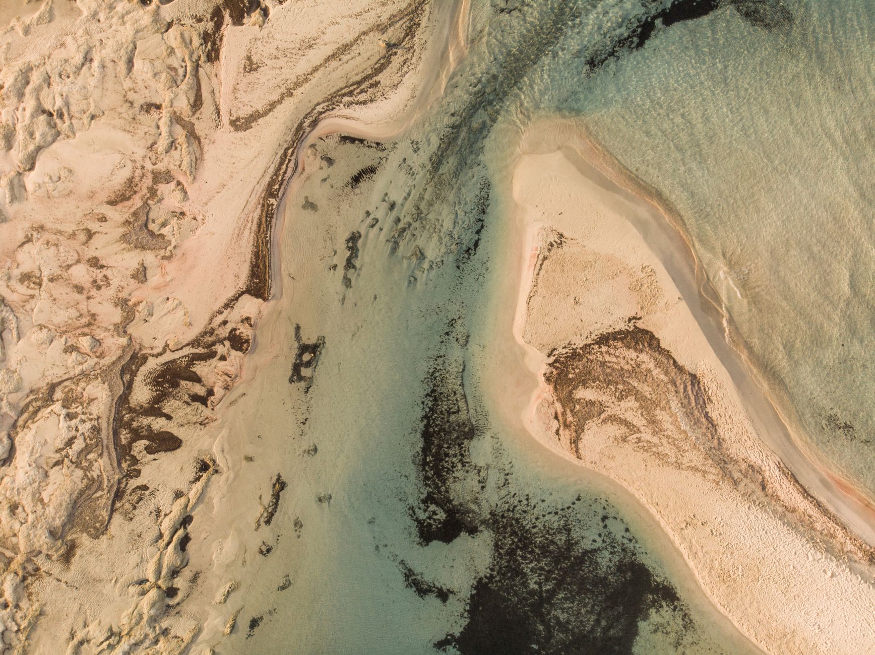 Stunning aerial view of Elafonissi Beach showcasing unique sand formations and turquoise waters.