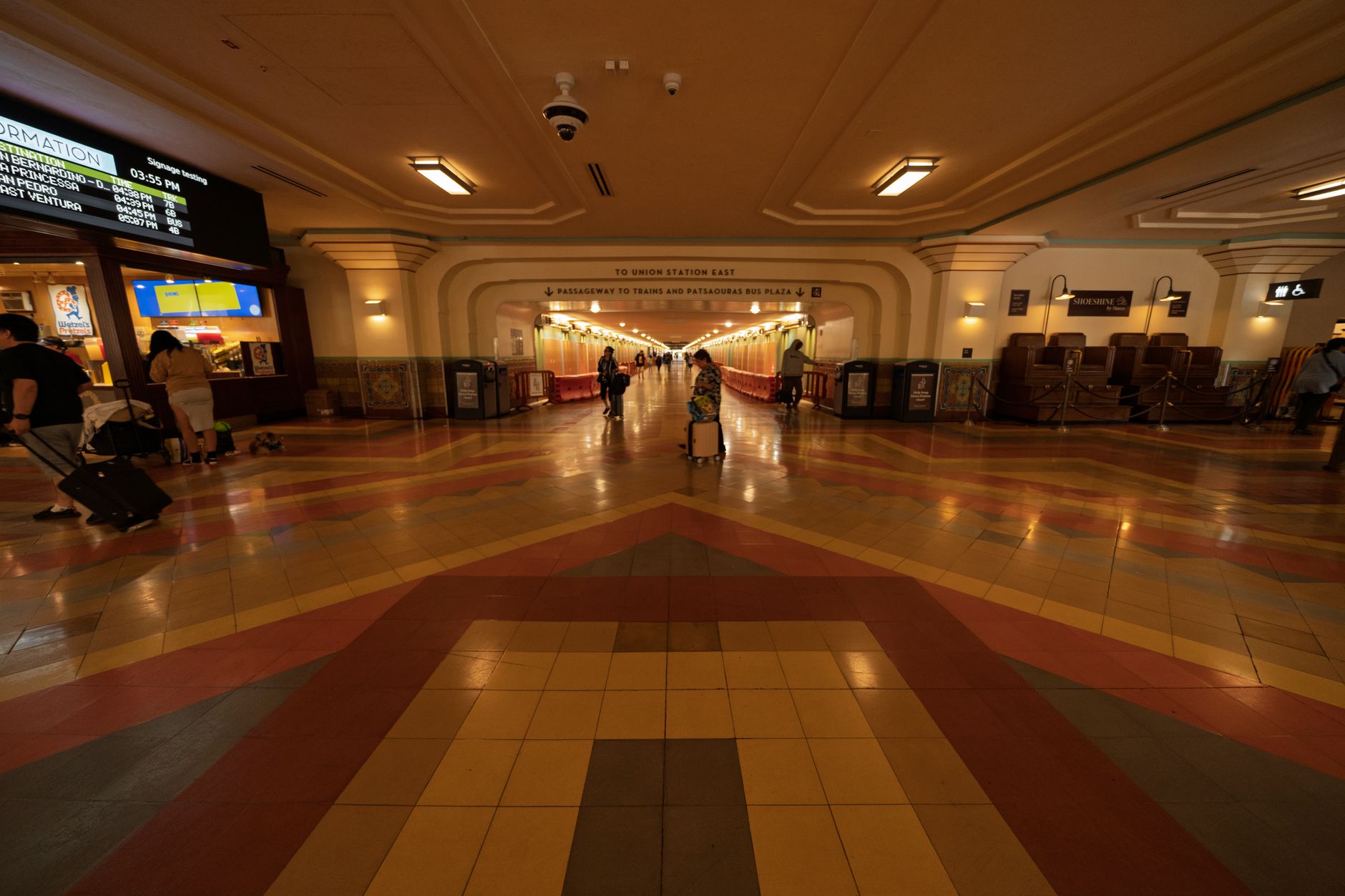 Wide-angle view of Union Station's tile flooring with passengers walking.